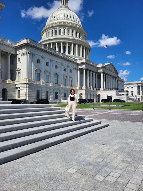 Jeanette Ickovics, PhD, standing in front of the U.S. Capitol