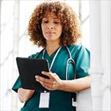 female healthcare professional looking at tablet