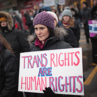 protester holding sign: trans rights are human rights
