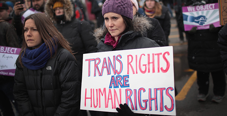 protester holding sign: trans rights are human rights