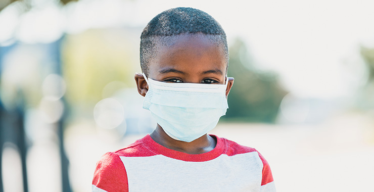young boy wearing medical mask