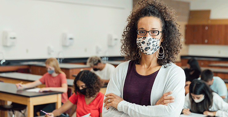 Teacher with mask in classroom