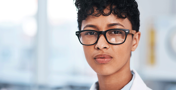 woman wearing glasses and a lab coat