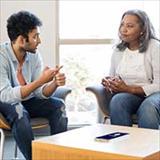 Young adult male meets with his mental health therapist for emotional support