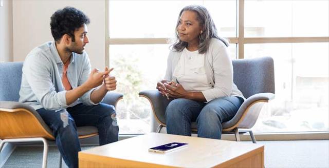 Young adult male meets with his mental health therapist for emotional support