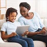 Mother and young son looking at his tablet