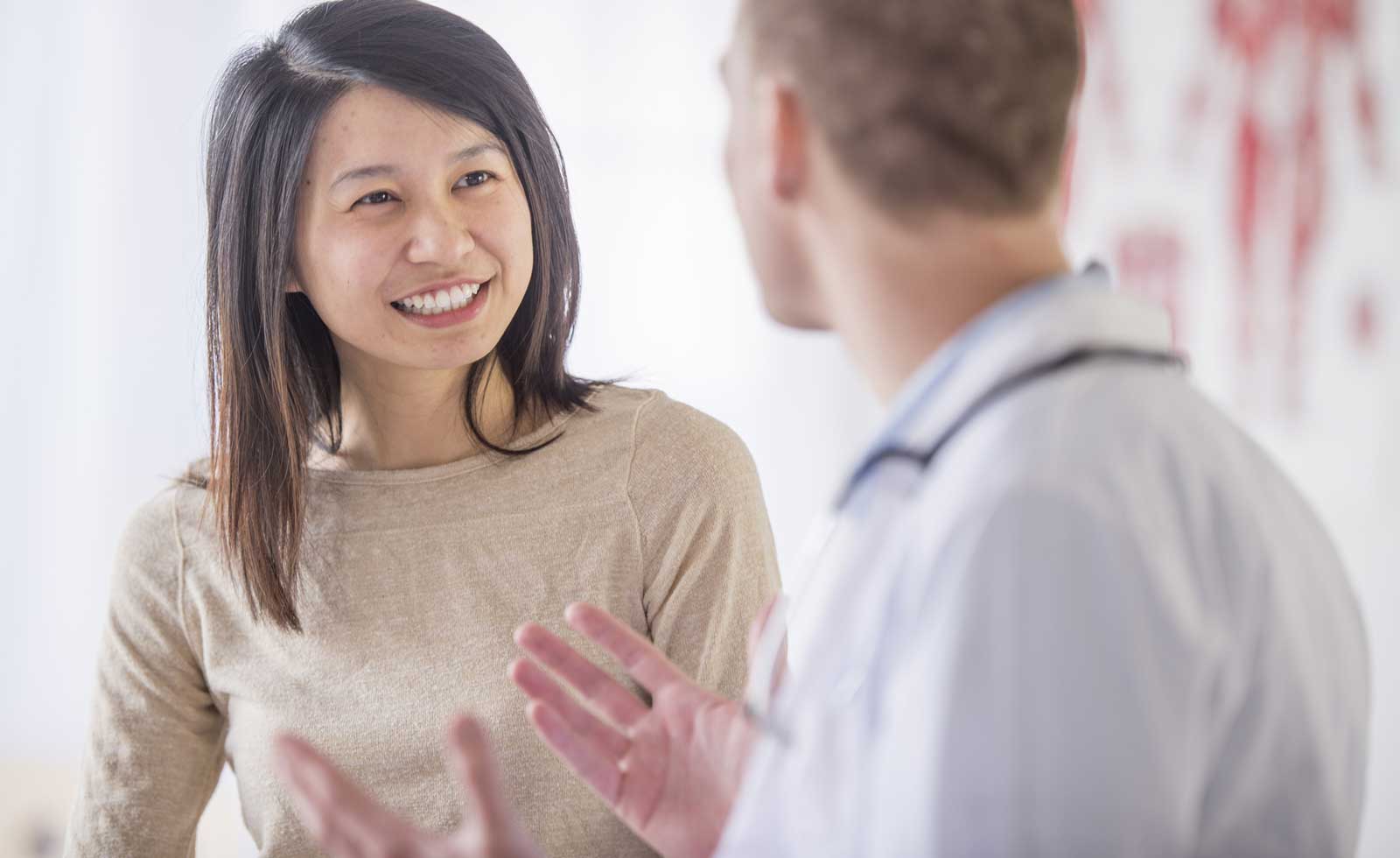 Young woman speaking with healthcare professional 