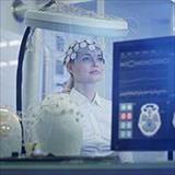 Scientist examining brainwave scanning headset in laboratory
