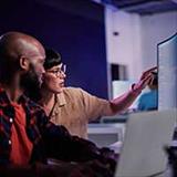 people working together at computer screen