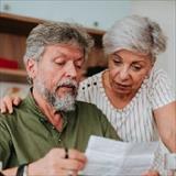 Senior couple looking at a medical bill