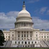 The United States Capitol building in Washington, D.C., viewed from the front under a partly cloudy sky.