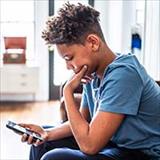 Teenage kid looking at smartphone