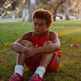 Boy sitting alone in an empty park