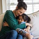 Mom and daughter hugging on couch
