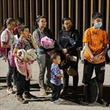 A group of immigrants standing outside