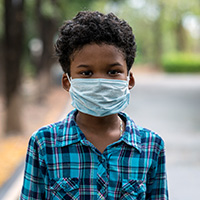 Young boy wearing a medical face mask