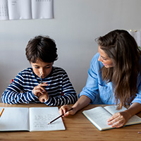Teacher looking over school work with student