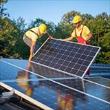 Workers installing solar panels