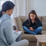 Young girl talking with a psychologists