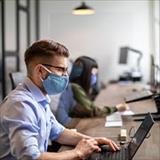 Office employees sitting at a computer desk