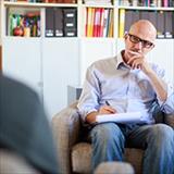 Psychologists meeting with patient and taking notes