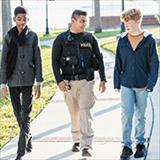 Police walking with two teenage boys