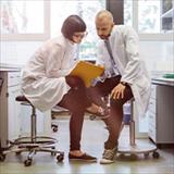 Scientist in a lab looking at a file