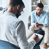 Psychologist taking notes in a session