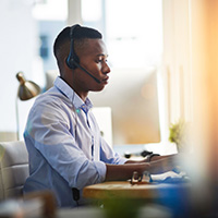 Man at desk wearing a headset