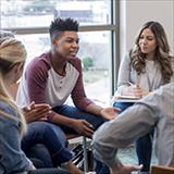 Teenage students in discussion with psychologists