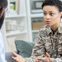 Military woman speaking with a doctor