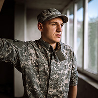 Man in military uniform gazing out of a window