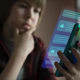 Young boy using system AI Chatbot on mobile application