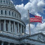close-up of Capitol with American flag