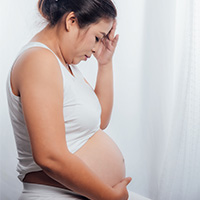 Pregnant woman touching her stomach