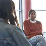 Sad woman sharing with friends and instructor