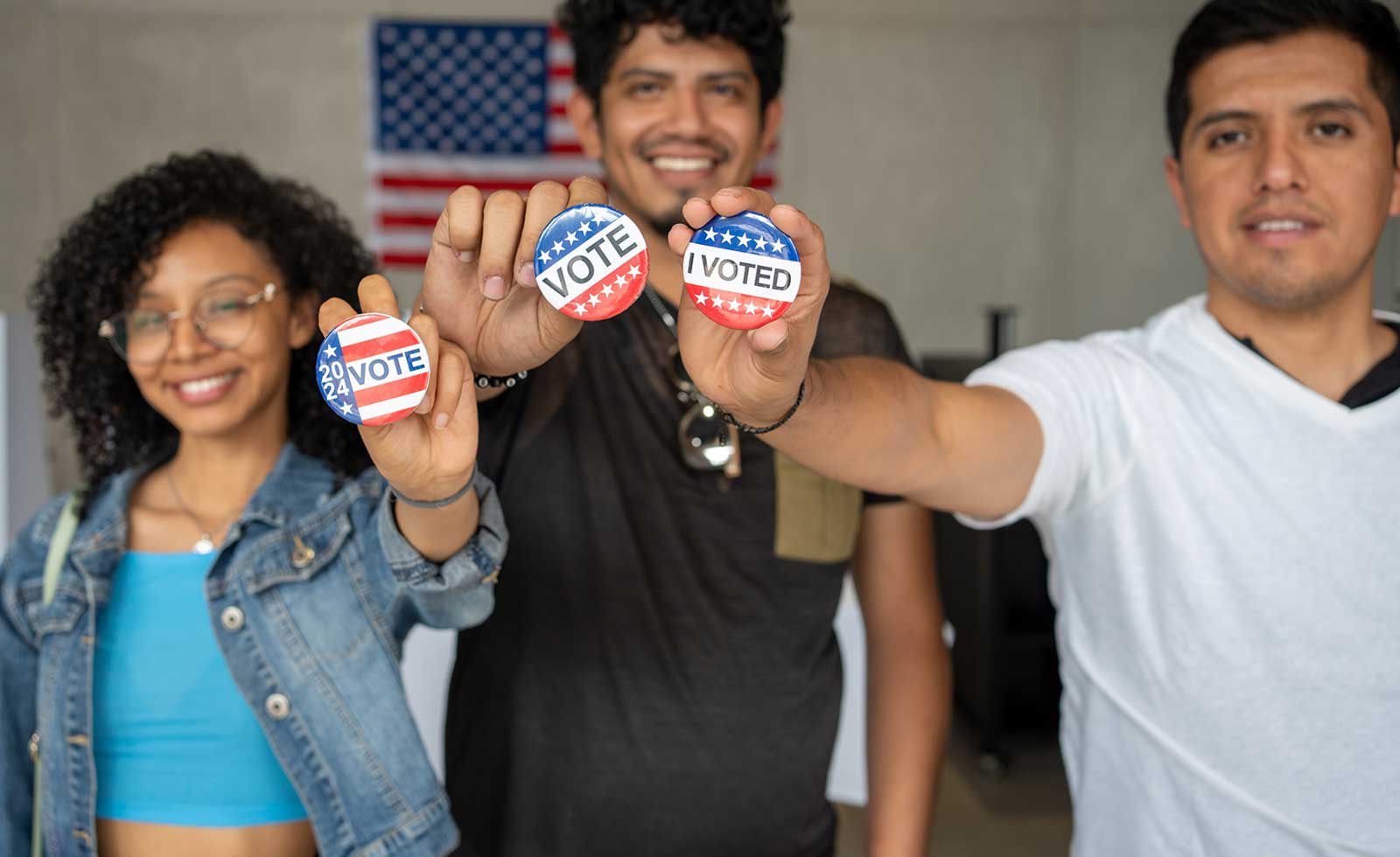 young people holding buttons saying I Voted