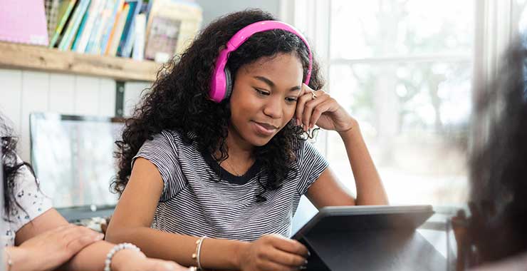 teen girl looking at tablet computer