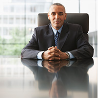 man in a suit at board room table