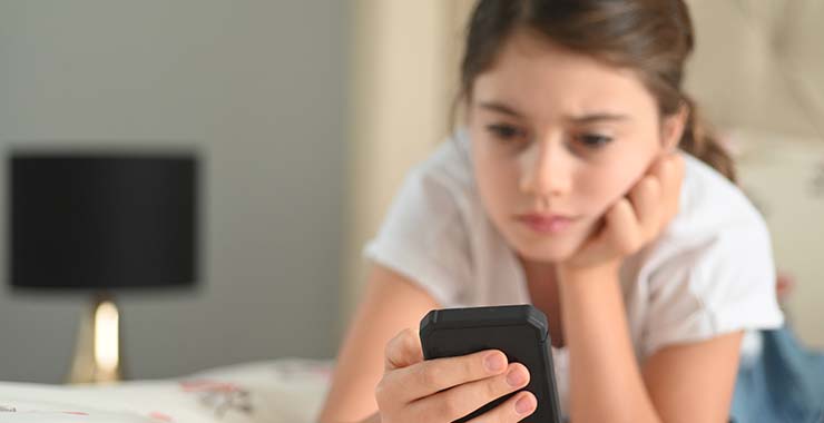 girl looking at mobile phone