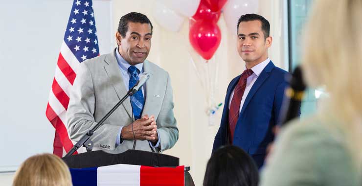 politician taking questions from audience at town hall meeting