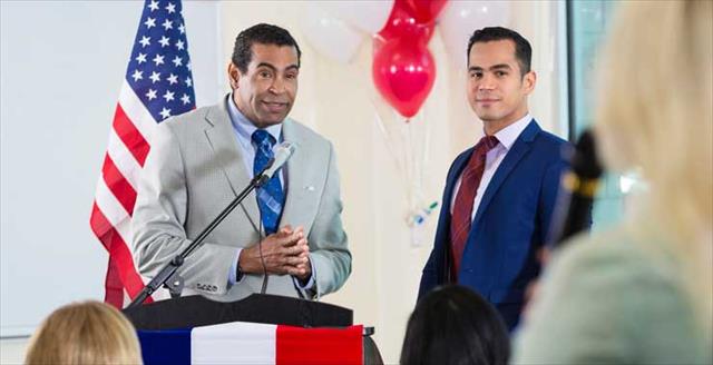 politician taking questions from audience at town hall meeting