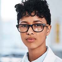 woman wearing glasses and a lab coat