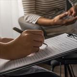 therapist filling out assessment form