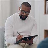 Black male therapist doing assessment during therapy session