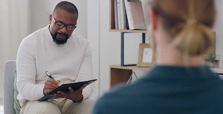 Black male therapist doing assessment during therapy session