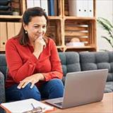 Middle age woman looking at her laptop