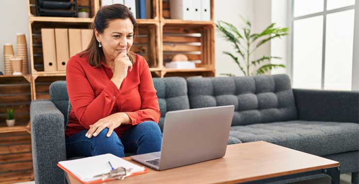 Middle age woman looking at her laptop
