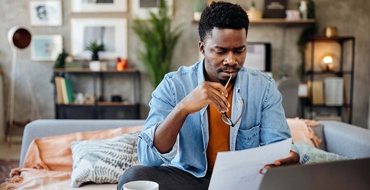 Man looking at student loan bill