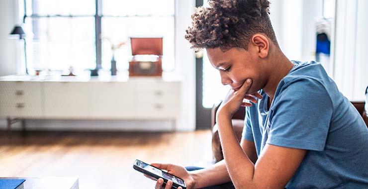 Teenage kid looking at smartphone